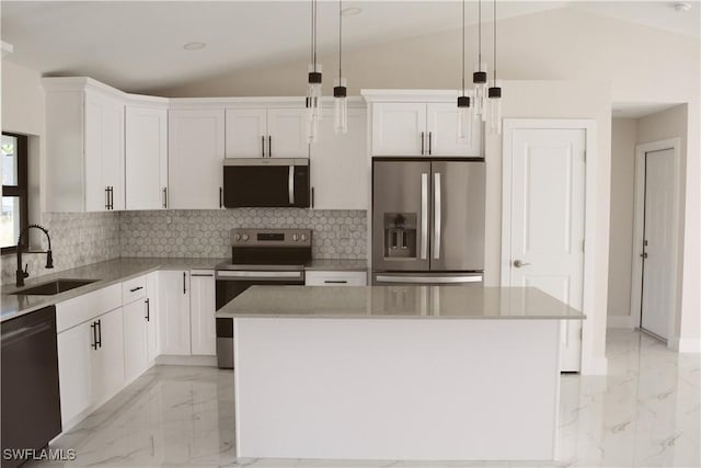 1013 Agnes Ave, Lehigh Acres, FL 33971 - kitchen with stainless steel appliances, a sink, light marble finish floors, vaulted ceiling, and white cabinets