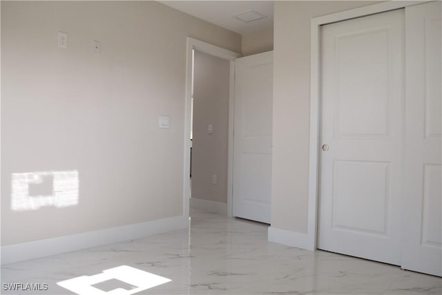 1013 Agnes Ave, Lehigh Acres, FL 33971 - unfurnished bedroom with light marble finish floors, baseboards, and a closet