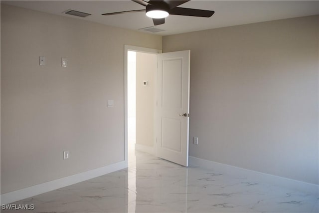 1013 Agnes Ave, Lehigh Acres, FL 33971 - empty room featuring a ceiling fan, light marble finish flooring, and baseboards