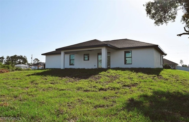 1013 Agnes Ave, Lehigh Acres, FL 33971 - prairie-style home with stucco siding and a front yard