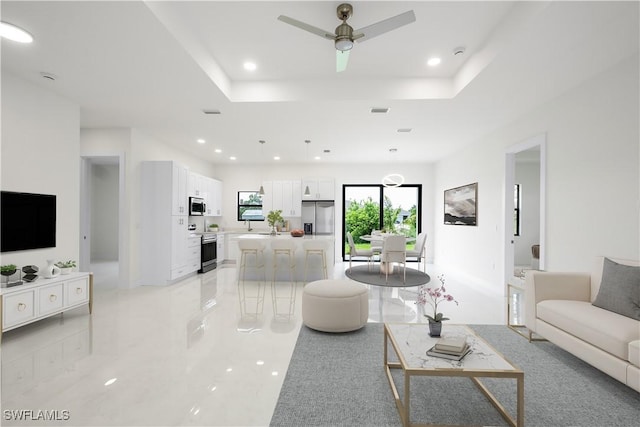 2811 27th St SW, Lehigh Acres, FL 33976 - living area featuring ceiling fan, a tray ceiling, and recessed lighting