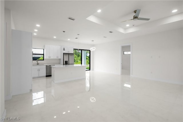 2811 27th St SW, Lehigh Acres, FL 33976 - kitchen featuring stainless steel appliances, a center island, white cabinets, recessed lighting, and light countertops