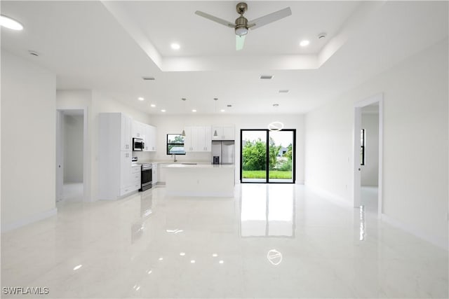 2811 27th St SW, Lehigh Acres, FL 33976 - unfurnished living room with a raised ceiling, ceiling fan, recessed lighting, and baseboards