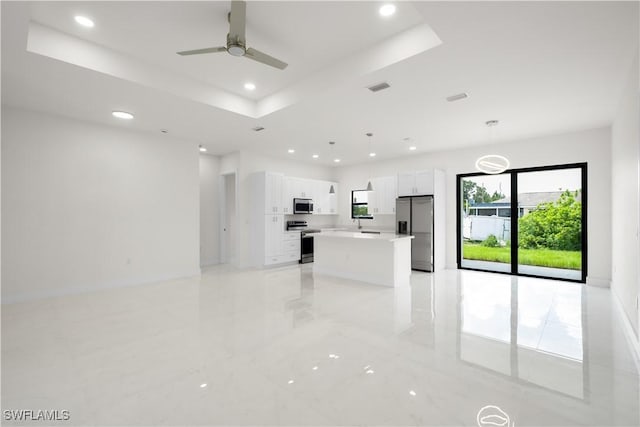 2811 27th St SW, Lehigh Acres, FL 33976 - unfurnished living room featuring recessed lighting, a raised ceiling, ceiling fan, and light marble finish floors