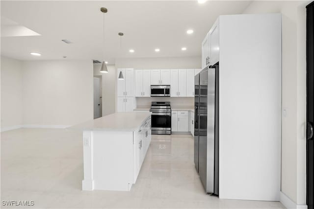 2811 27th St SW, Lehigh Acres, FL 33976 - kitchen with stainless steel appliances, light countertops, a kitchen island, recessed lighting, and white cabinetry