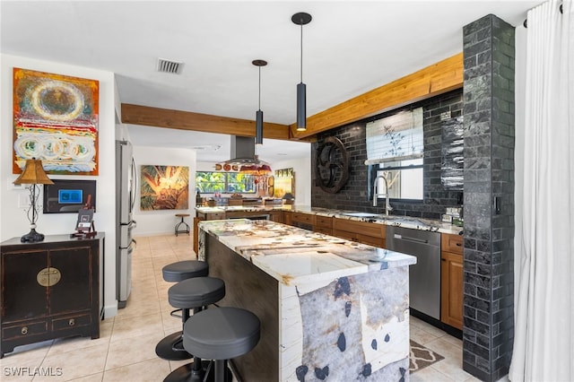 5631 Shaddelee Ln W, Fort Myers, FL 33919 - kitchen with stainless steel appliances, light tile patterned floors, a kitchen island, a kitchen bar, and decorative backsplash
