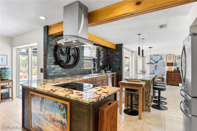 5631 Shaddelee Ln W, Fort Myers, FL 33919 - kitchen featuring stainless steel appliances, island exhaust hood, light tile patterned flooring, light stone counters, and decorative backsplash