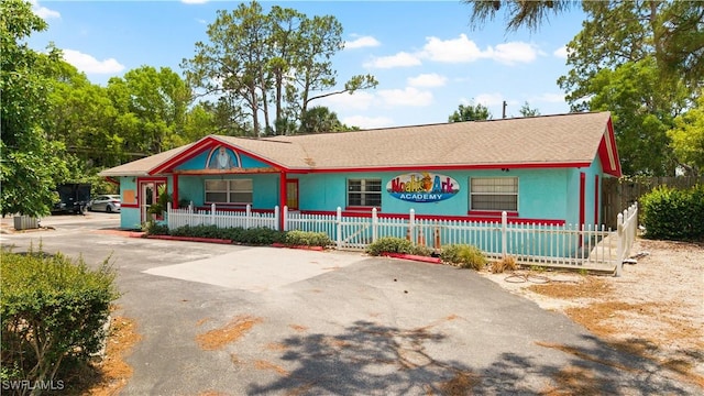 860 102nd Ave N, Naples, FL 34108 - view of front of home with a fenced front yard, covered porch, and driveway