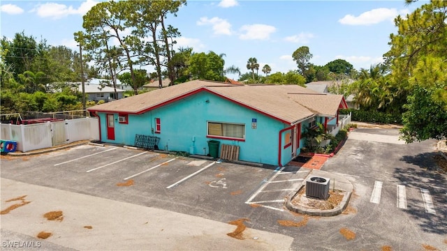 860 102nd Ave N, Naples, FL 34108 - view of property featuring uncovered parking and cooling unit