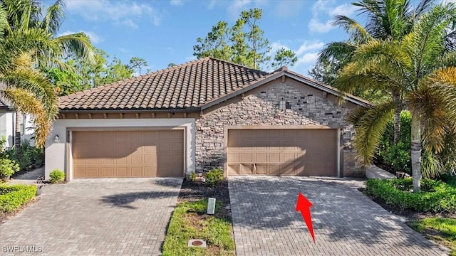 9052 Glenforest Dr, Naples, FL 34120 - view of front of property featuring stone siding, a tile roof, driveway, stucco siding, and an attached garage