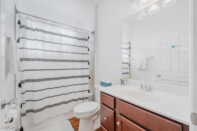 9052 Glenforest Dr, Naples, FL 34120 - full bathroom featuring vanity, toilet, shower / bath combination with curtain, and wood finished floors