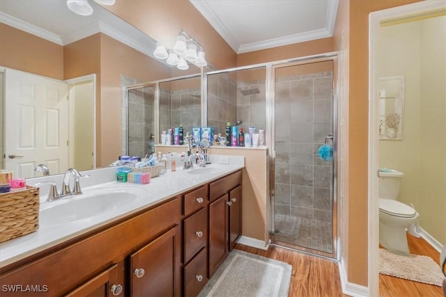 9052 Glenforest Dr, Naples, FL 34120 - full bath featuring double vanity, wood finished floors, a stall shower, crown molding, and toilet