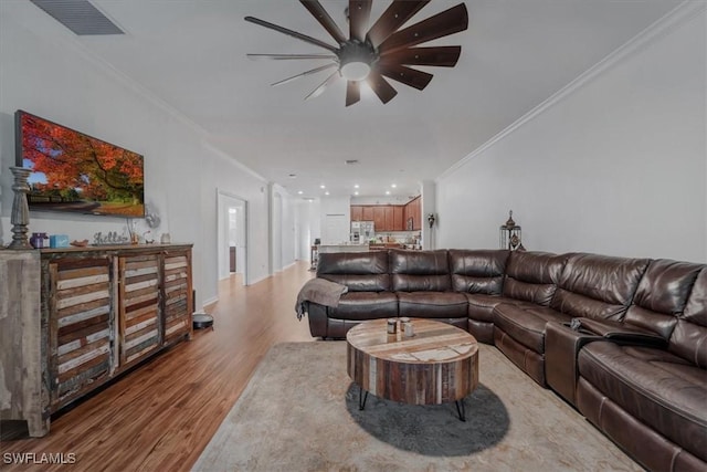 9052 Glenforest Dr, Naples, FL 34120 - living area featuring wood finished floors, ornamental molding, and a ceiling fan