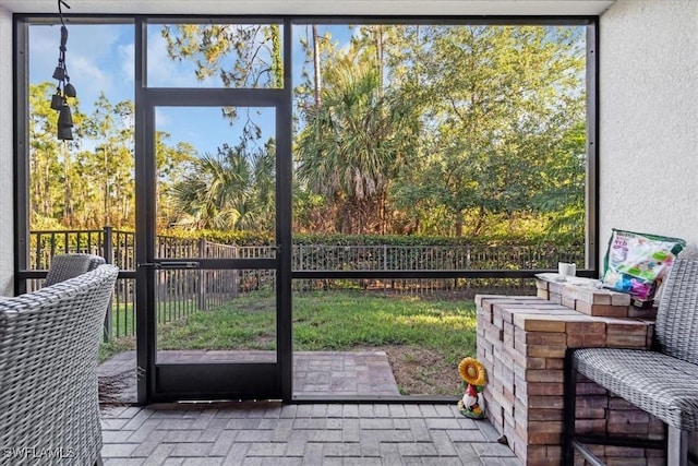 9052 Glenforest Dr, Naples, FL 34120 - doorway to outside with brick flooring and expansive windows