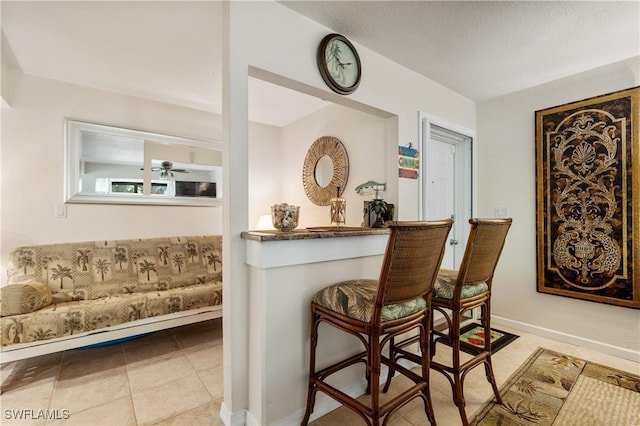 5483 Peppertree Dr Unit 1, Fort Myers, FL 33908 - indoor dry bar with tile patterned flooring, a ceiling fan, and baseboards