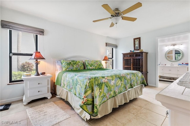 5483 Peppertree Dr Unit 1, Fort Myers, FL 33908 - bedroom with light tile patterned floors, multiple windows, ensuite bathroom, and baseboards