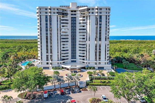 6001 Pelican Bay Blvd Unit 1405, Naples, FL 34108 - view of apartment building / complex featuring uncovered parking and a water view