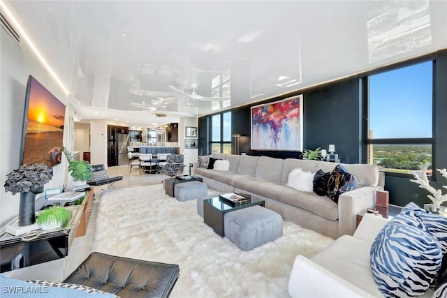 6001 Pelican Bay Blvd Unit 1405, Naples, FL 34108 - living room featuring ceiling fan and plenty of natural light