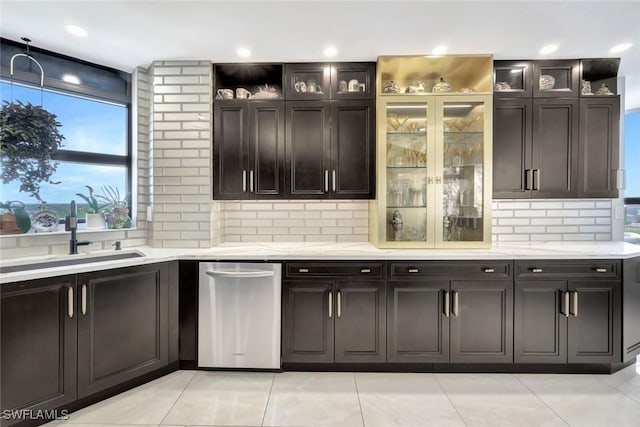 6001 Pelican Bay Blvd Unit 1405, Naples, FL 34108 - kitchen with a sink, backsplash, light tile patterned floors, and glass insert cabinets