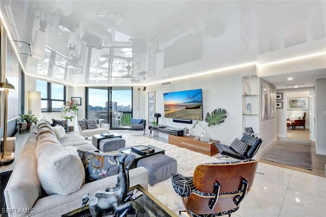 6001 Pelican Bay Blvd Unit 1405, Naples, FL 34108 - tiled living area featuring a high ceiling and baseboards