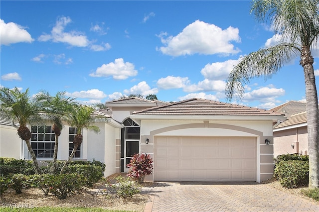 19741 Vintage Trace Cir, Estero, FL 33967 - view of front of property with stucco siding, a tiled roof, an attached garage, and driveway