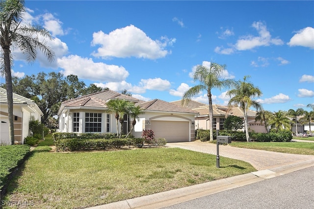 19741 Vintage Trace Cir, Estero, FL 33967 - view of front of house featuring driveway, stucco siding, an attached garage, and a front yard
