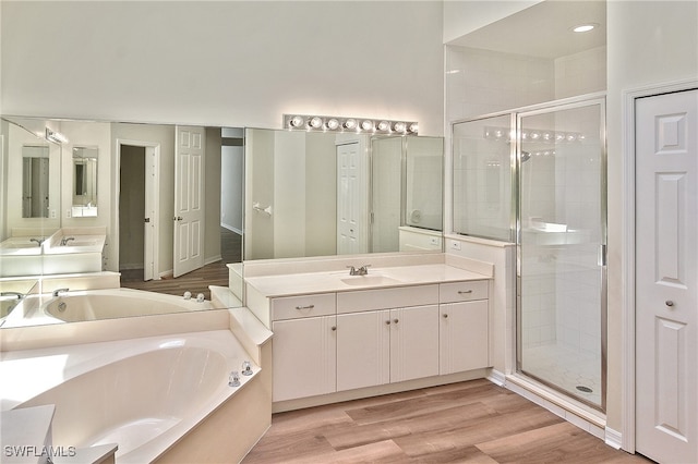 19741 Vintage Trace Cir, Estero, FL 33967 - full bath featuring a stall shower, a bath, vanity, and wood finished floors