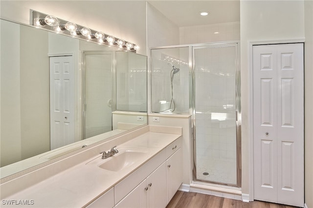 19741 Vintage Trace Cir, Estero, FL 33967 - bathroom with a closet, a stall shower, vanity, and wood finished floors