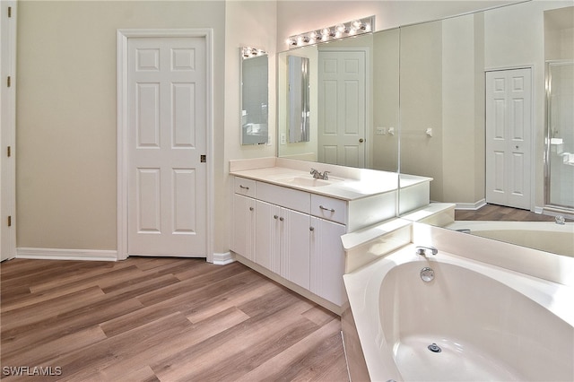 19741 Vintage Trace Cir, Estero, FL 33967 - full bath featuring vanity, a bath, wood finished floors, and baseboards