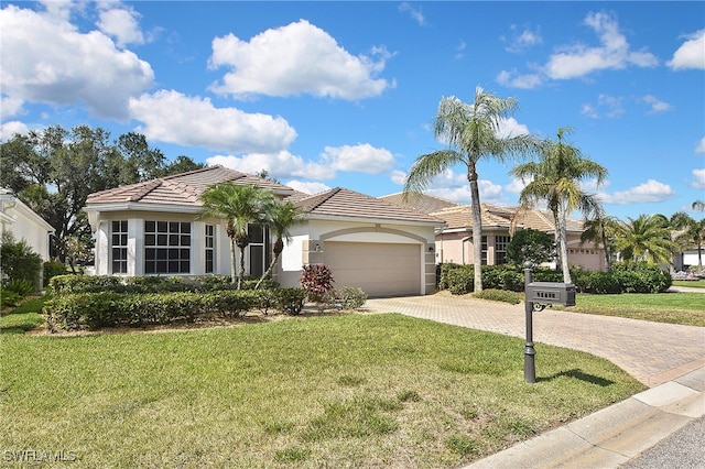 19741 Vintage Trace Cir, Estero, FL 33967 - ranch-style house with stucco siding, driveway, a front yard, an attached garage, and a tile roof