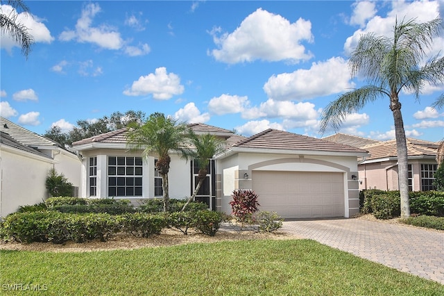 19741 Vintage Trace Cir, Estero, FL 33967 - view of front of home with a tiled roof, decorative driveway, an attached garage, and stucco siding
