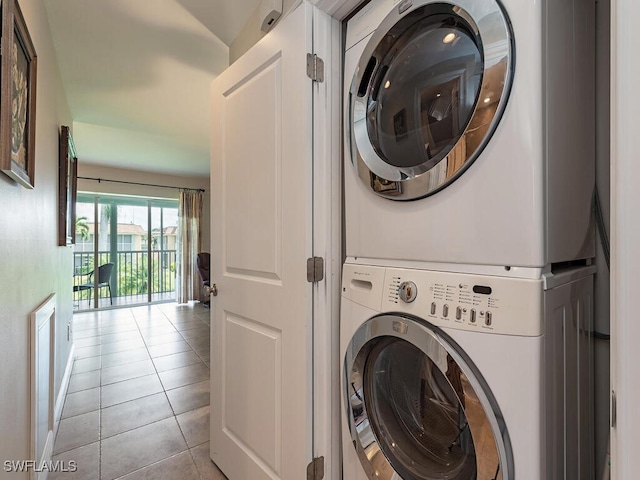 1400 Pompei Ln Unit 2, Naples, FL 34103 - washroom featuring stacked washer and clothes dryer and light tile patterned flooring