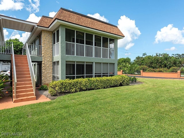 1400 Pompei Ln Unit 2, Naples, FL 34103 - back of property featuring stucco siding, a lawn, a shingled roof, and stairway
