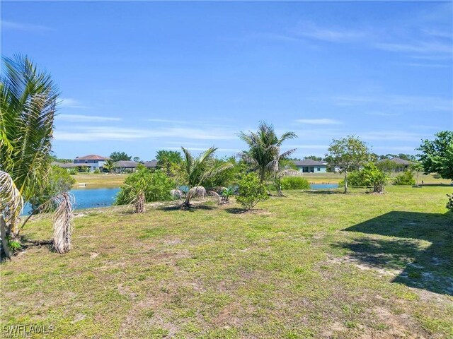 154 Shadowview Ct, Lehigh Acres, FL 33974 - view of grassy yard featuring a water view