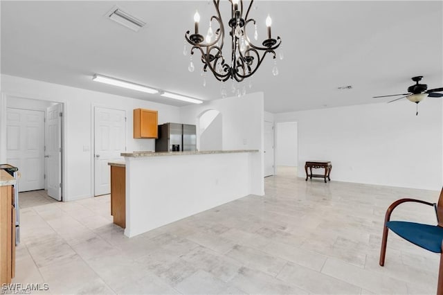 154 Shadowview Ct, Lehigh Acres, FL 33974 - kitchen with stainless steel fridge with ice dispenser, ceiling fan, a chandelier, a peninsula, and pendant lighting