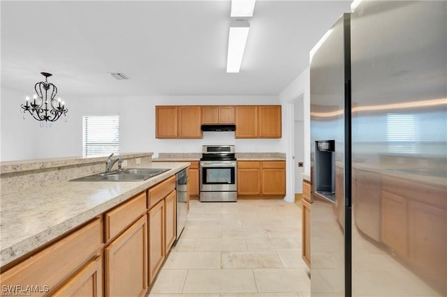 154 Shadowview Ct, Lehigh Acres, FL 33974 - kitchen with appliances with stainless steel finishes, ventilation hood, a sink, light countertops, and pendant lighting