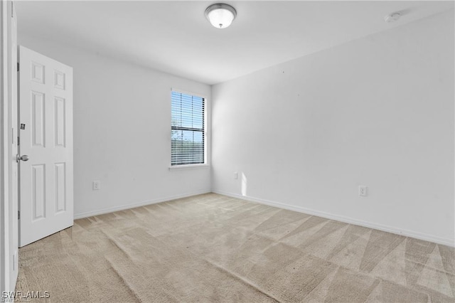 154 Shadowview Ct, Lehigh Acres, FL 33974 - carpeted empty room featuring baseboards and a smoke detector