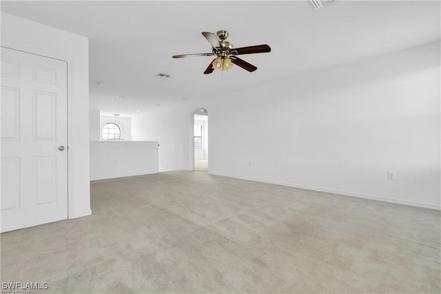 154 Shadowview Ct, Lehigh Acres, FL 33974 - unfurnished living room with ceiling fan, light carpet, and arched walkways