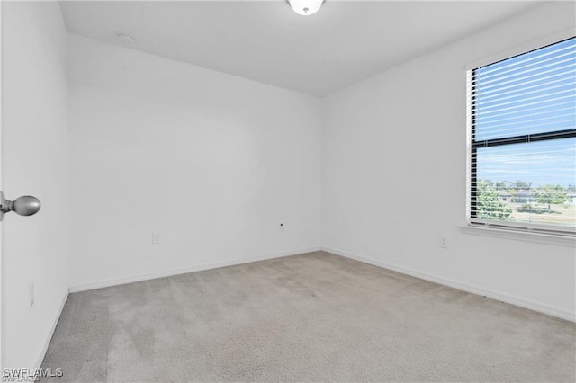 154 Shadowview Ct, Lehigh Acres, FL 33974 - spare room featuring carpet and baseboards