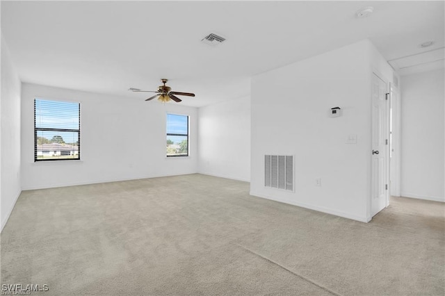 154 Shadowview Ct, Lehigh Acres, FL 33974 - carpeted empty room with plenty of natural light, ceiling fan, and baseboards