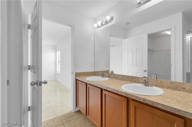 154 Shadowview Ct, Lehigh Acres, FL 33974 - full bathroom featuring double vanity, tile patterned floors, and a walk in closet