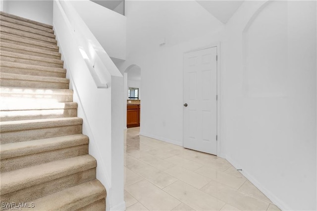 154 Shadowview Ct, Lehigh Acres, FL 33974 - staircase featuring arched walkways and baseboards