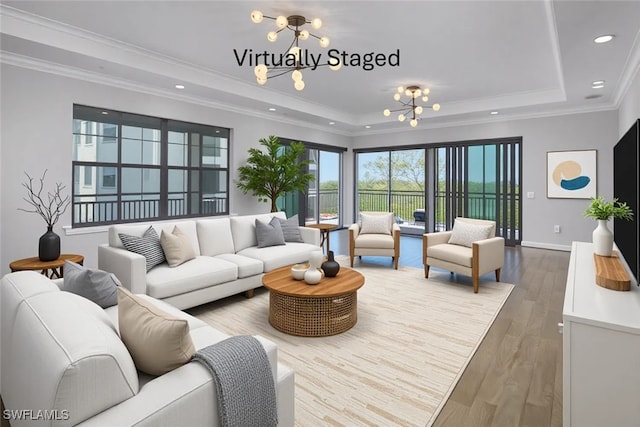 4771 Via Del Corso Ln Unit 302, Bonita Springs, FL 34134 - living area with a chandelier, a tray ceiling, crown molding, wood finished floors, and recessed lighting
