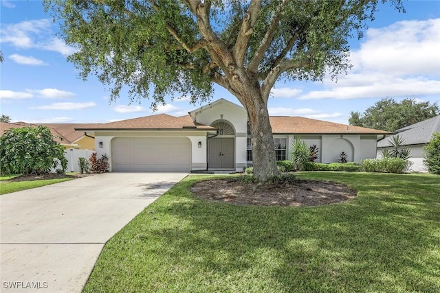 10268 Boca Cir, Naples, FL 34109 - view of front of home with stucco siding, an attached garage, and concrete driveway