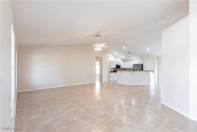 2121 NW 18th Pl, Cape Coral, FL 33993 - unfurnished living room with ceiling fan, light tile patterned floors, vaulted ceiling, and baseboards