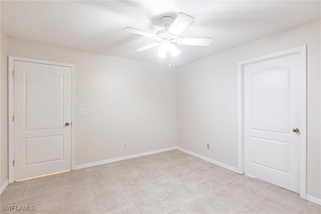 2121 NW 18th Pl, Cape Coral, FL 33993 - empty room with a ceiling fan, baseboards, and light tile patterned floors