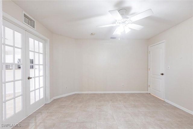 2121 NW 18th Pl, Cape Coral, FL 33993 - empty room featuring plenty of natural light, french doors, light tile patterned flooring, and baseboards