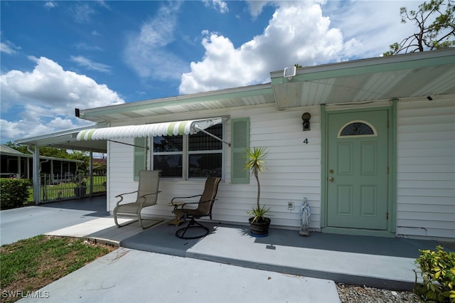4 Desert Candle Cir, Lehigh Acres, FL 33936 - property entrance with a carport and concrete driveway