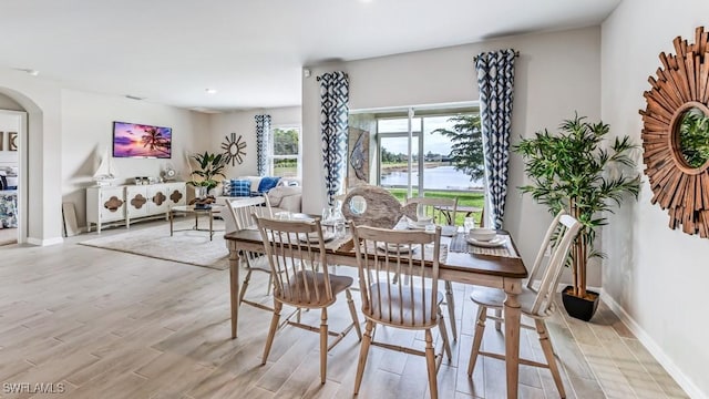 1255 Brumfield Xing, Fort Myers, FL 33905 - dining room featuring light wood-style flooring, baseboards, recessed lighting, and arched walkways