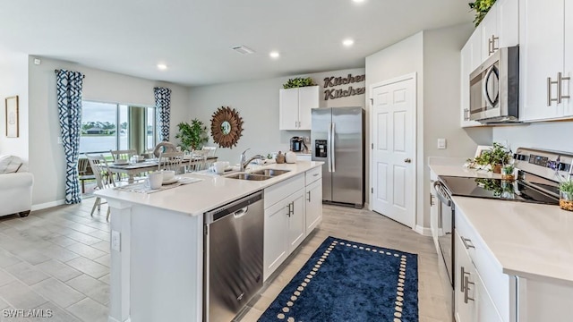 1255 Brumfield Xing, Fort Myers, FL 33905 - kitchen with stainless steel appliances, a sink, light countertops, recessed lighting, and white cabinetry